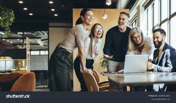 stock-photo-happy-businesspeople-laughing-while-collaborating-on-a-new-project-in-an-office-gr...jpg
